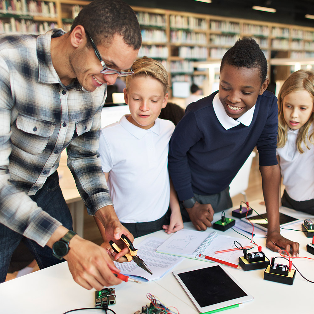 School children making circuits in library