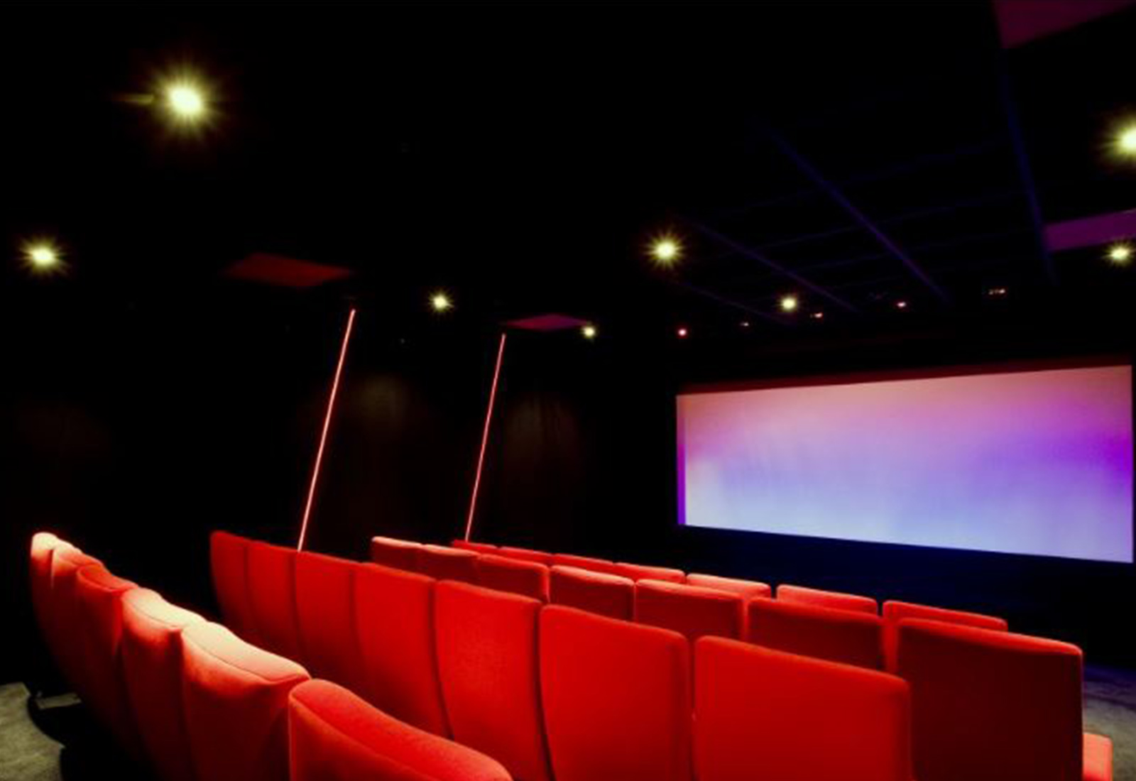 Red chairs in front of screen