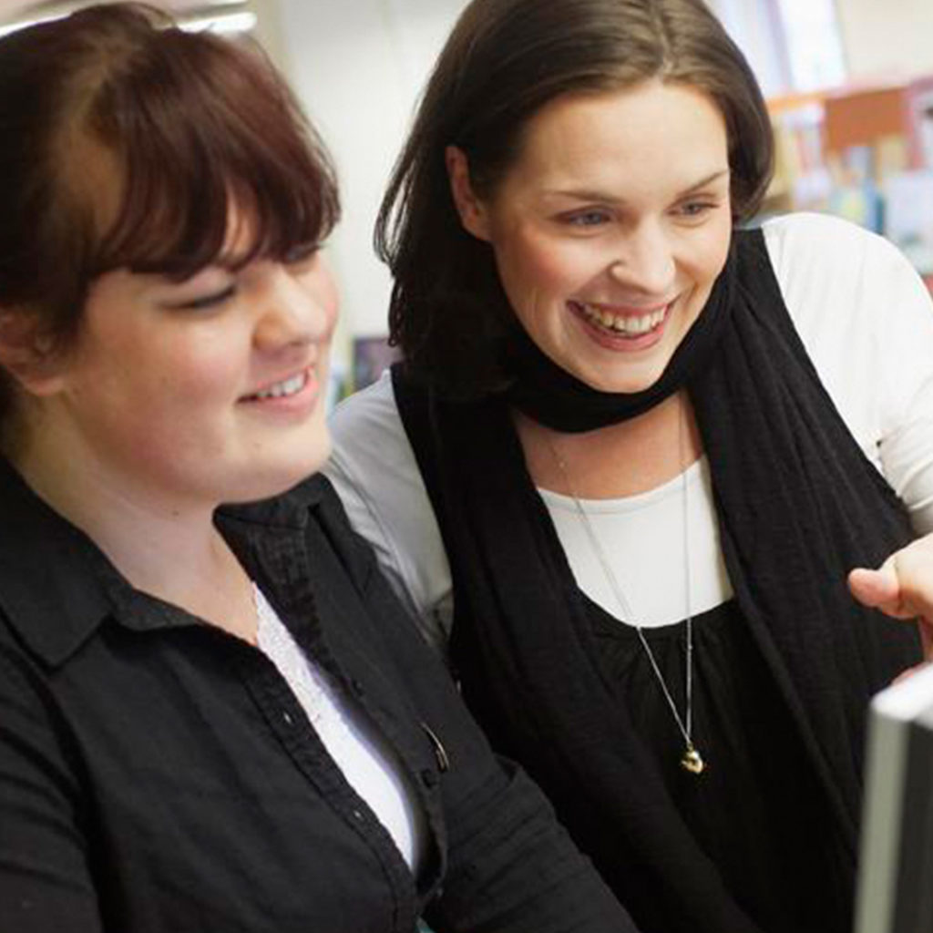 Girls looking at library screen