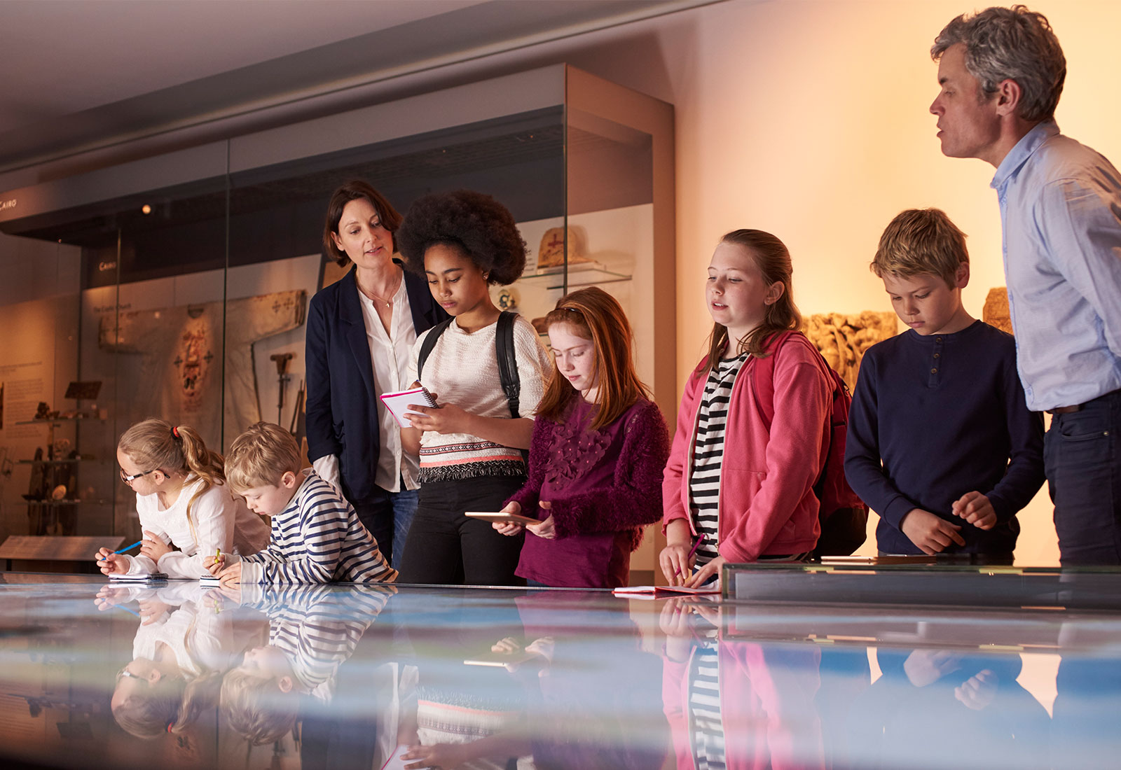 Children making notes on an exhibition