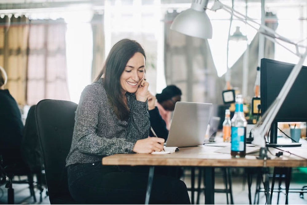 Woman writing notes in Library