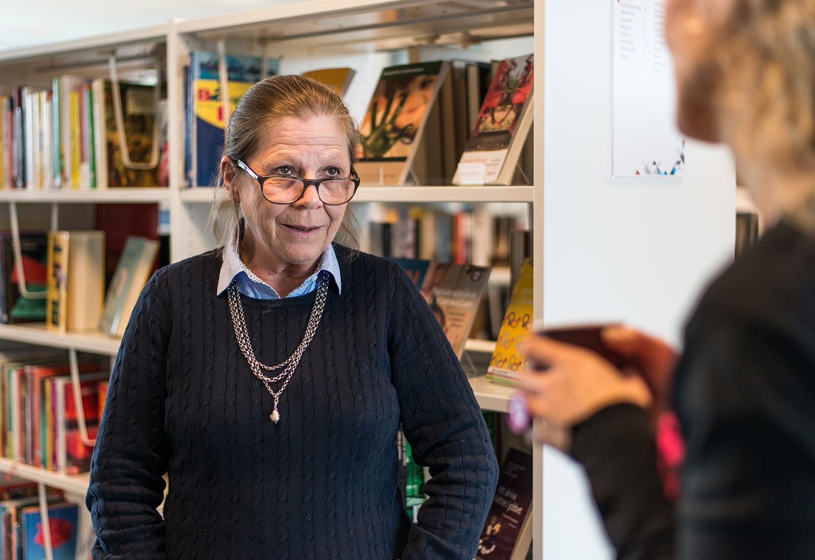 A librarian infront of books