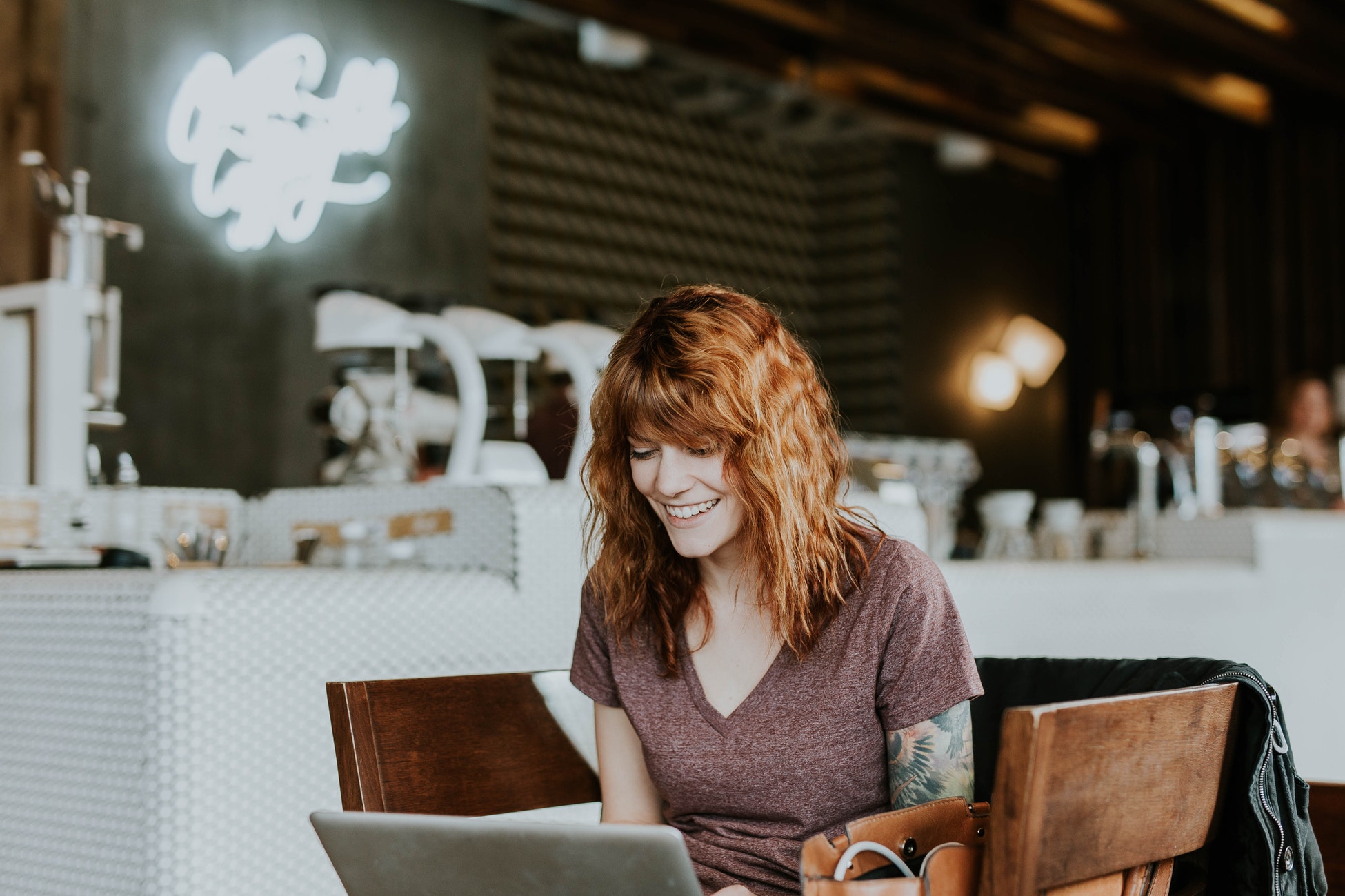 Woman using laptop in coffee shop